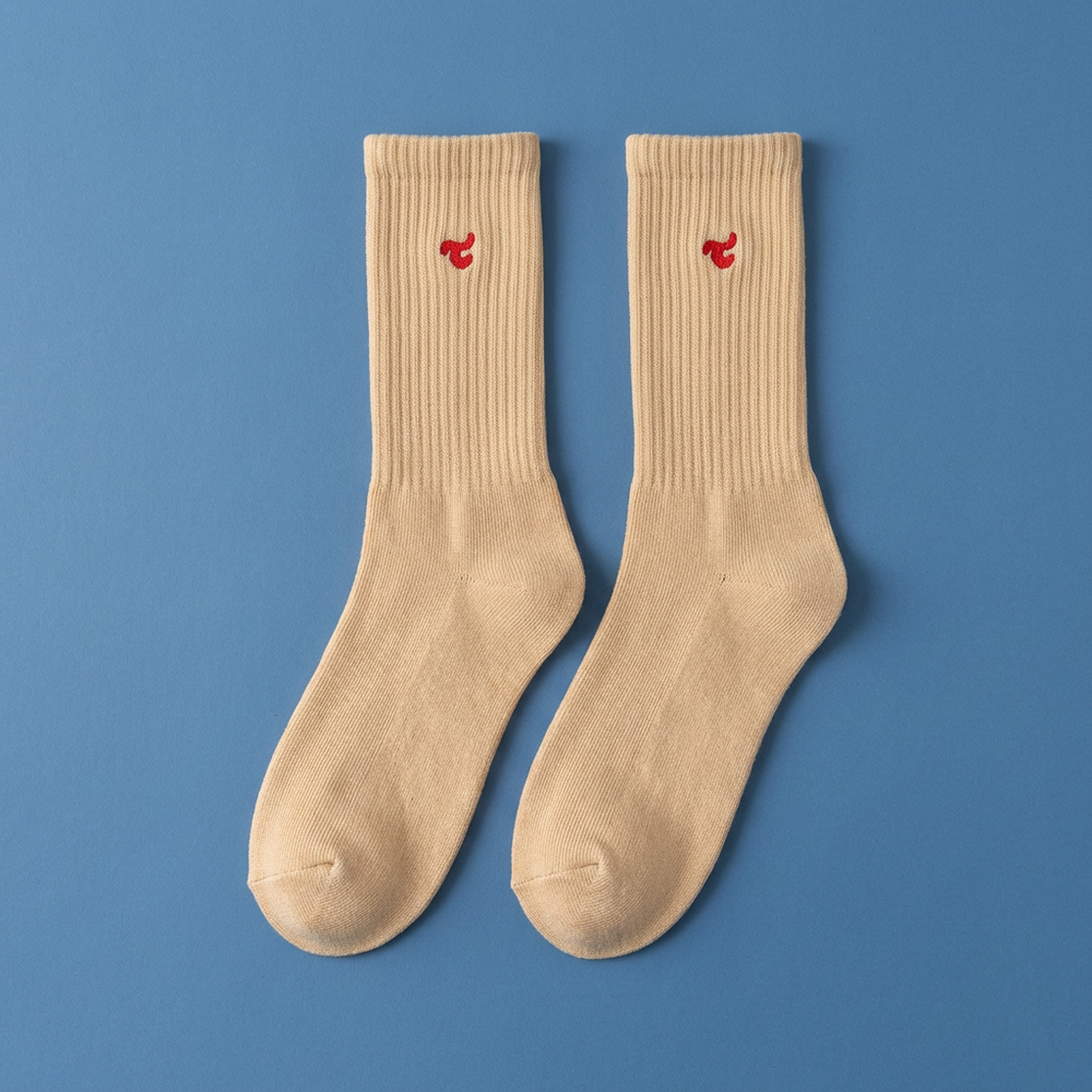 Tiny Socks 3-pack in Sugar Swizzle, a pair laid flat on a blue background.