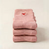 Tiny Socks 3-pack in barely pink, three pairs folded and stacked.