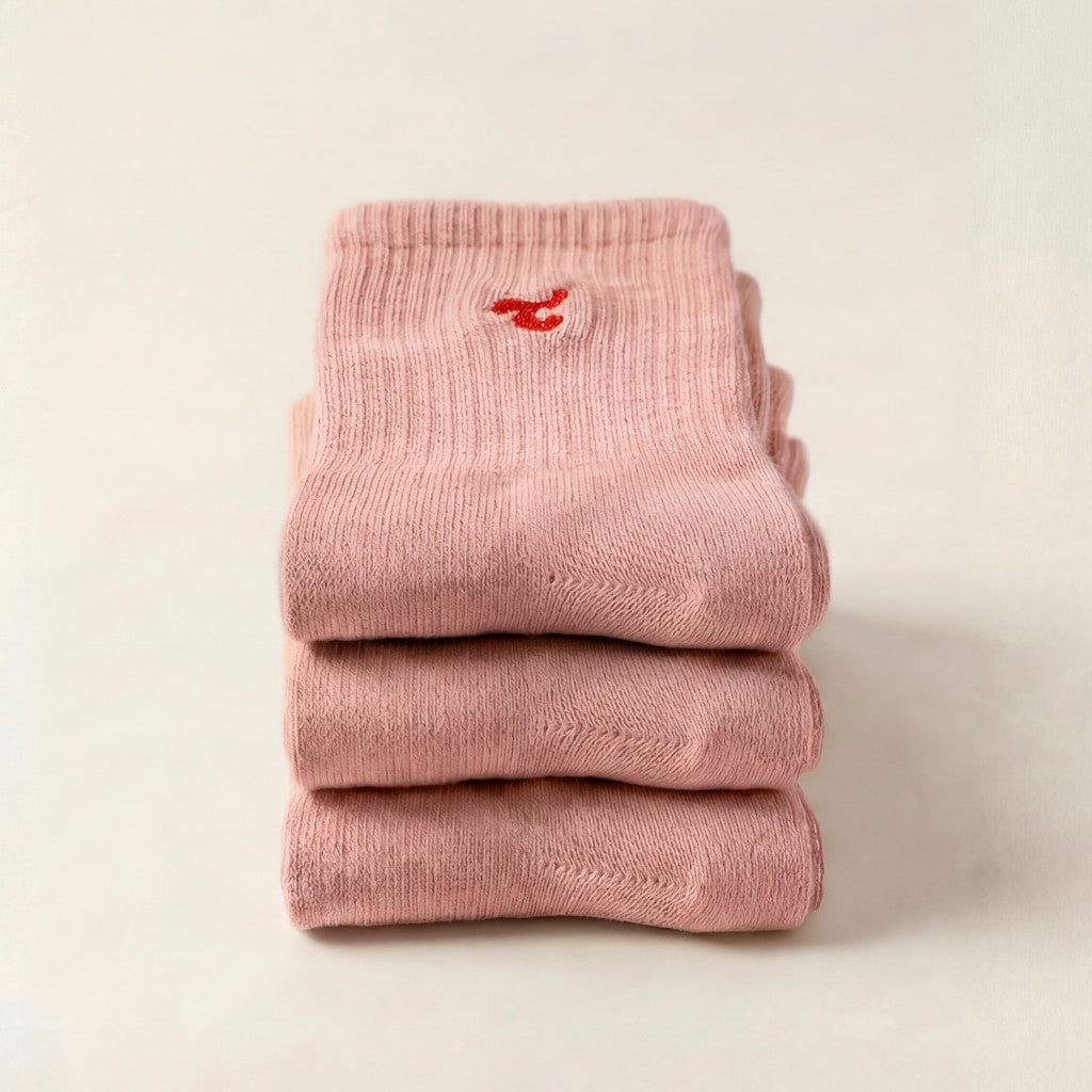Tiny Socks 3-pack in barely pink, three pairs folded and stacked.