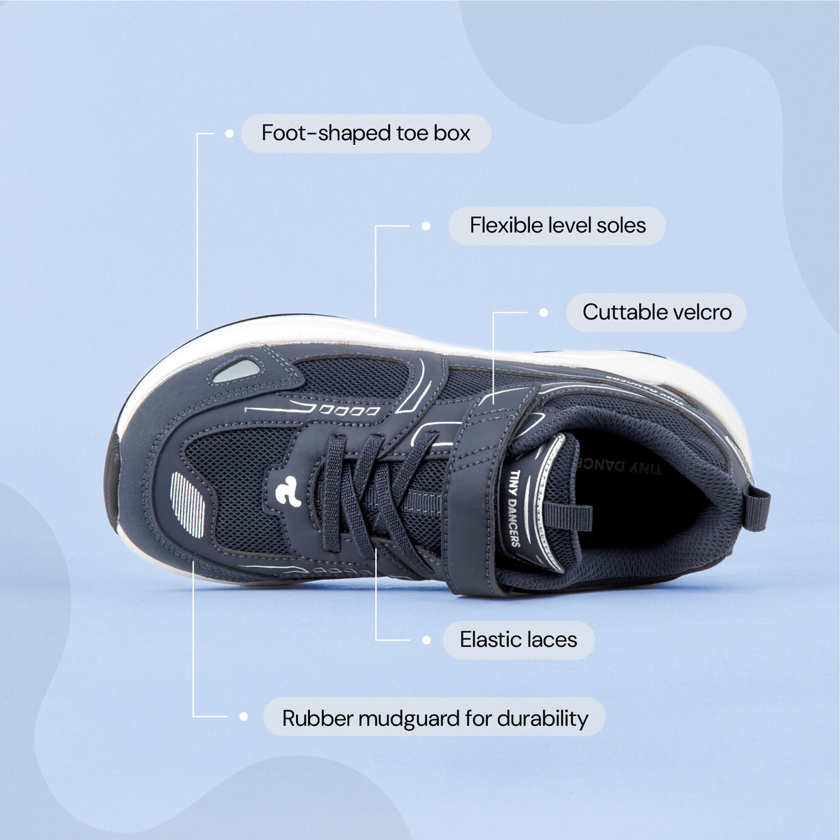 Play Junior in navy from above, labelled: foot-shaped toe box, flexible level soles, cuttable velcro, elastic laces, rubber mudguard.