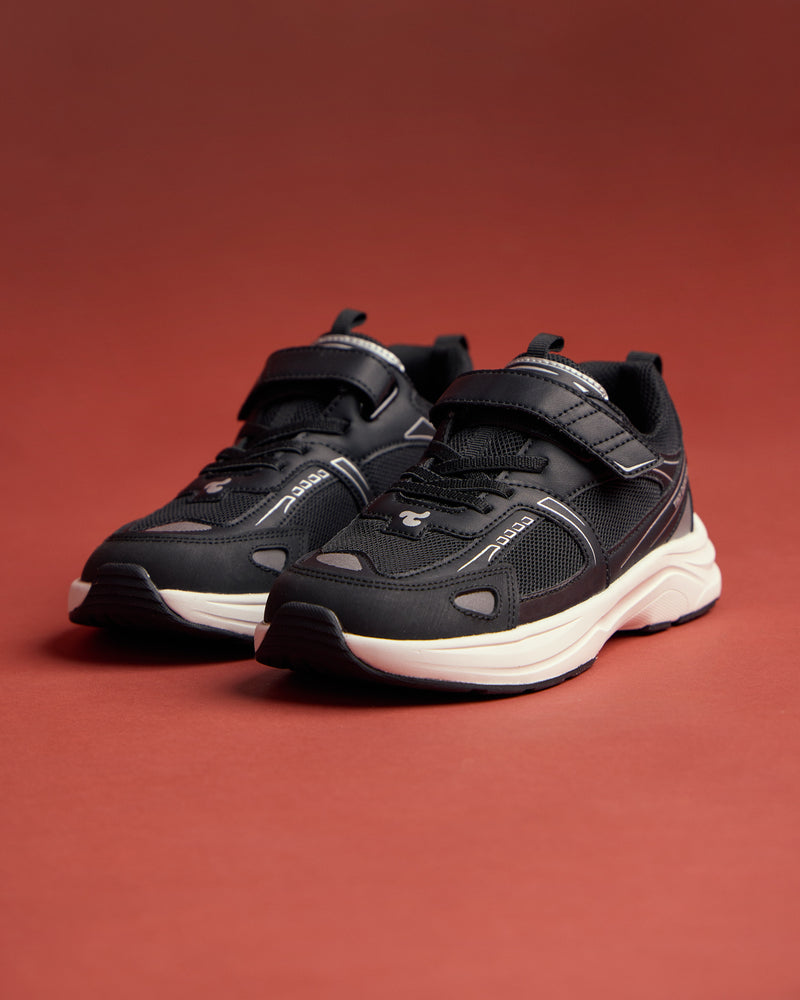 A pair of Play Junior black on a red background.
