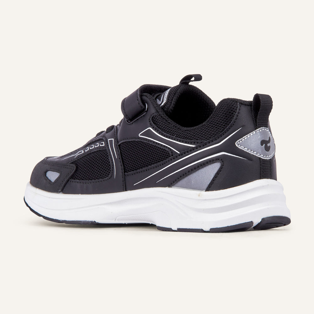 Play Junior in black from the inner side, mesh upper and white sole visible.