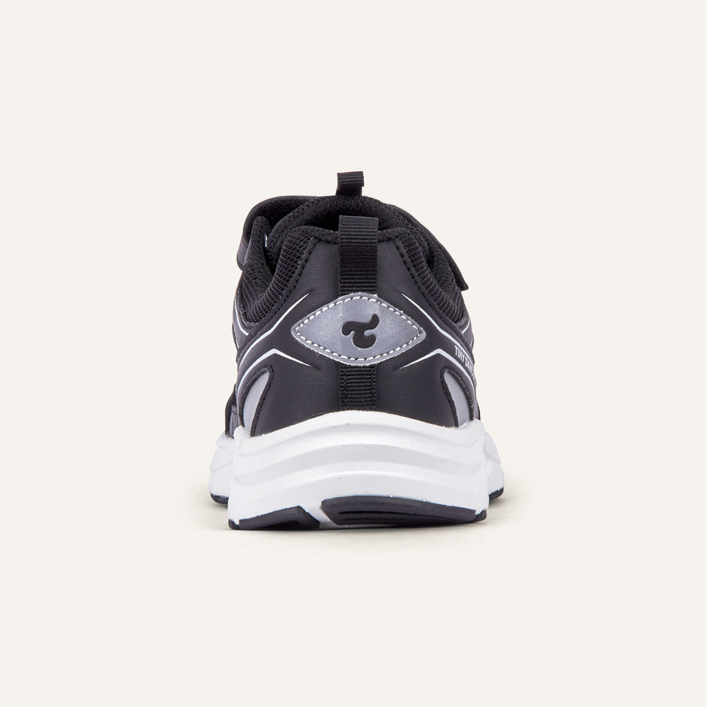 Play Junior in black, rear view with the Tiny Dancers logo on the heel.